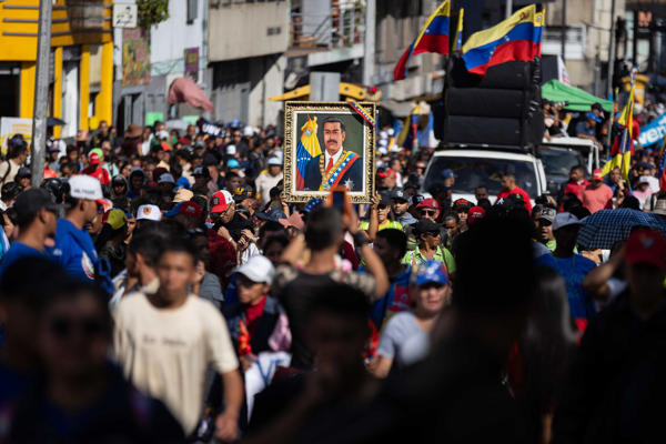 Jóvenes del PSUV marchan con un cuadro de Maduro